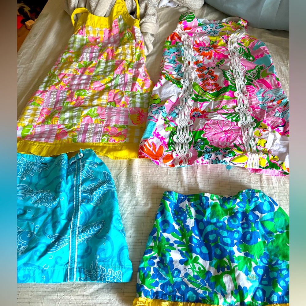 2 Lilly Pulitzer skirts and 2 Lilly Pulitzer dresses.  No stains or tears size 5